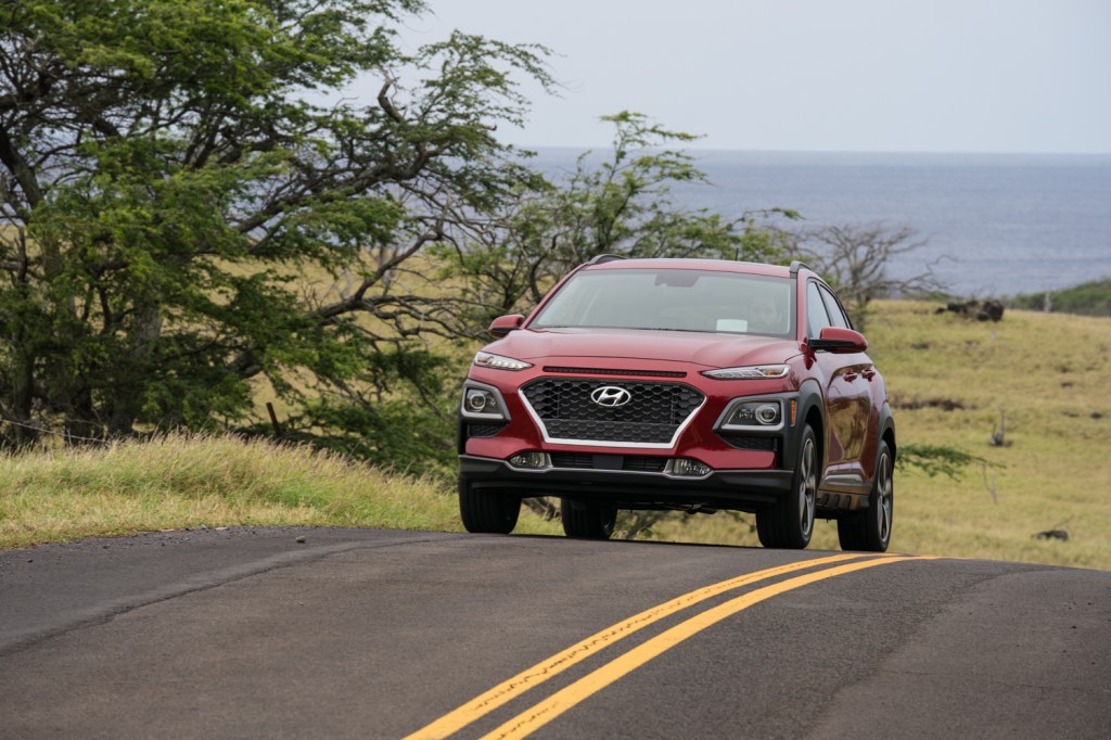 A red 2021 Hyundai Kona driving, the 2021 Hyundai Kona is one of the best commuter cars