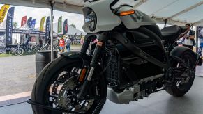 The front 3/4 view of a white 2021 LiveWire One under a tent