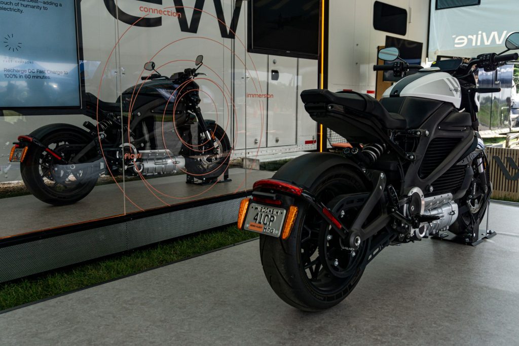 The rear 3/4 view of a white and black 2021 LiveWire One under a tent