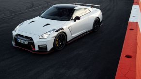 A white 2021 Nissan GT-R is parked on a race track.