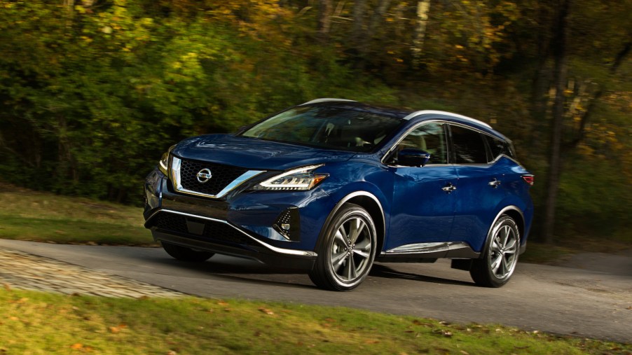 A blue 2021 Nissan Murano parked in the woods
