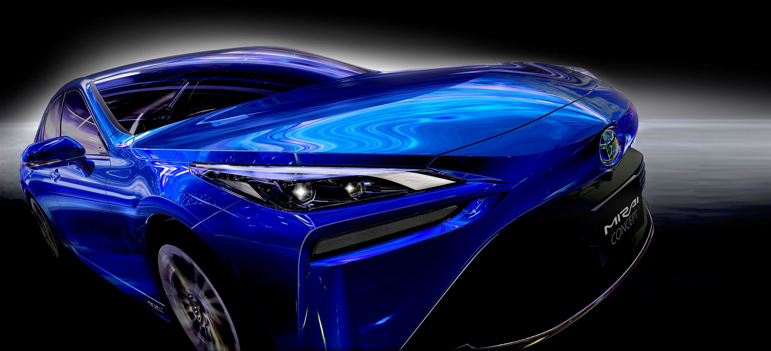 A blue 2021 Toyota Mirai in front of black background with a white glow around the car.