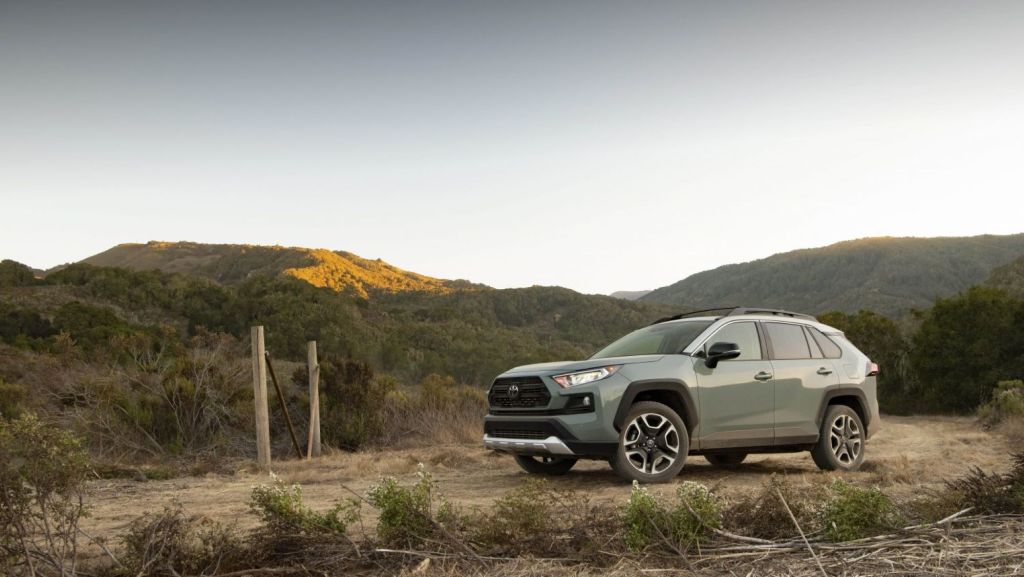 The 2021 Toyota RAV4 Adventure SUV parked on a dirt trail surrounded by grass hills
