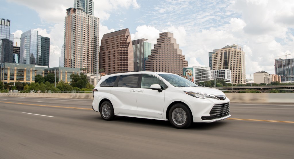 A white 2021 Toyota Sienna driving, the 2021 Toyota Sienna is one of the most satisfying new minivans