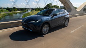 A 2021 Toyota Venza driving over a bridge on a sunny day