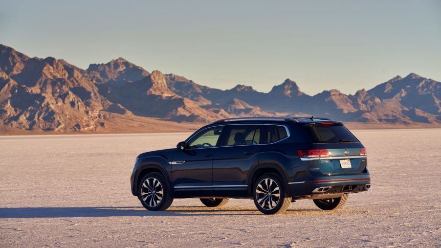 A dark blue 2021 Volkswagen Atlas SUV model parked in the middle of a desert plain