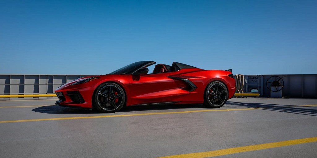 A red 2021 Chevy Corvette parked with a blue sky behind it.