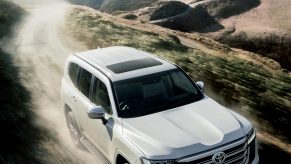 2022 Toyota Land Cruiser SUV driving off-road in the mountains