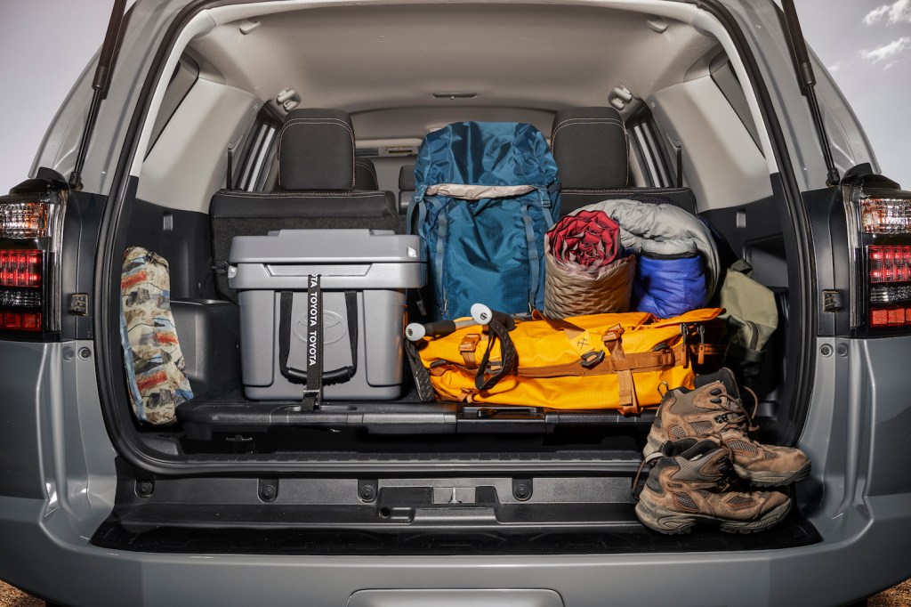 The cargo area of the 2021 Toyota 4Runner with a cooler and beach items shown inside of it, the 4Runner is one of the best midsize SUVs with the most cargo room