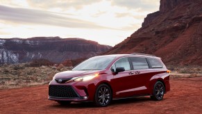 A red 2021 Toyota Sienna parked in the wilderness on a cloudy day