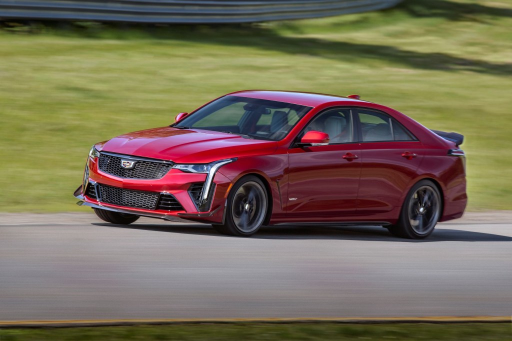 A red 2022 Cadillac CT4-V Blackwing goes around a racetrack corner