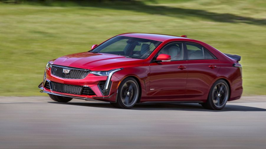A red 2022 Cadillac CT4-V Blackwing goes around a racetrack corner