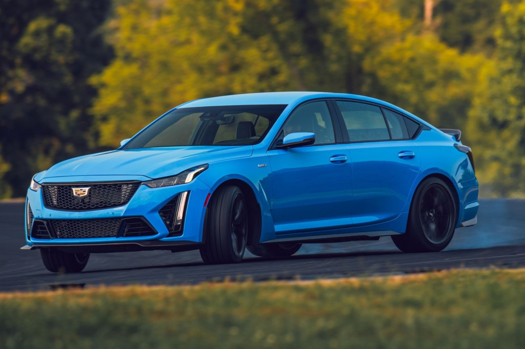 A blue 2022 Cadillac CT5-V Blackwing slides around a racetrack