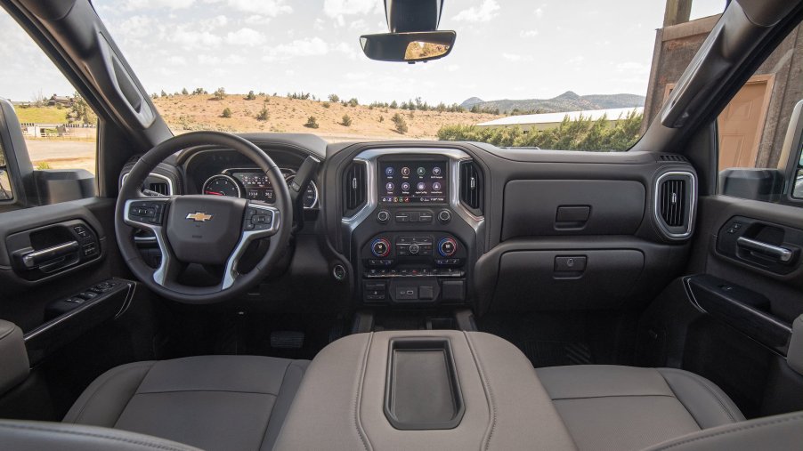 The taupe and black front seats and dashboard of a 2022 Chevrolet Silverado 2500 HD
