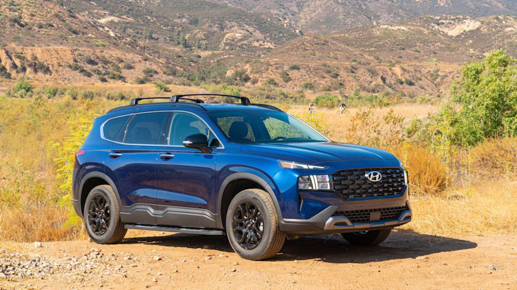 A blue 2022 Hyundai Santa Fe XRT off-roading in dirt
