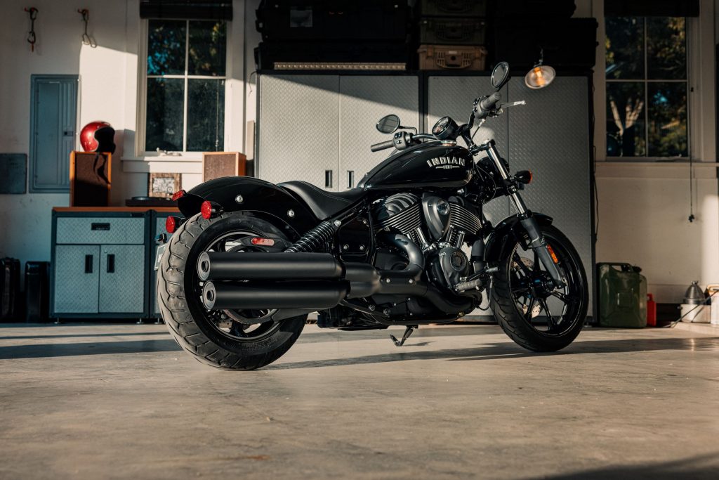 The rear 3/4 view of a black 2022 Indian Chief in a garage
