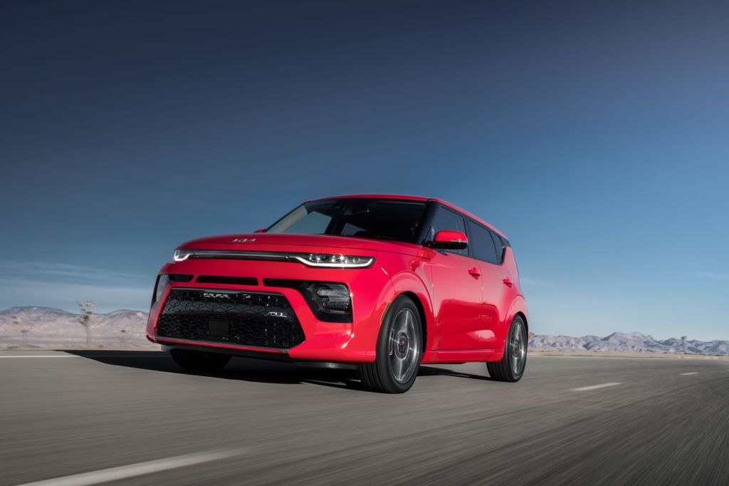 The 2022 Kia Soul CUV in red driving down a highway