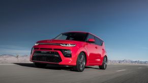 The 2022 Kia Soul CUV in red driving down a highway