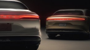 The rear view of a silver and a gold 2022 Lucid Air Dream Edition