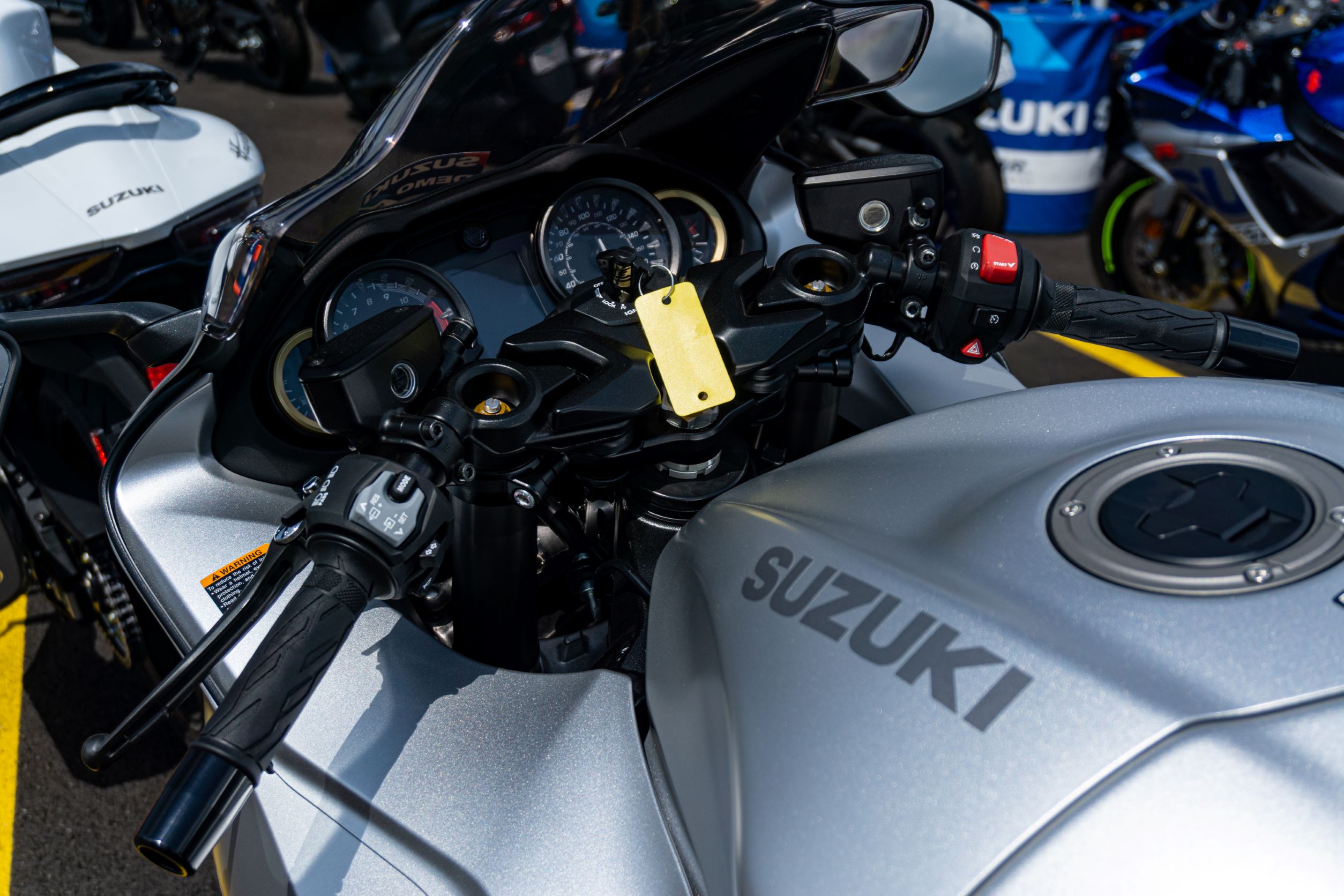 A close-up view of a silver 2022 Suzuki Hayabusa's handlebars and display