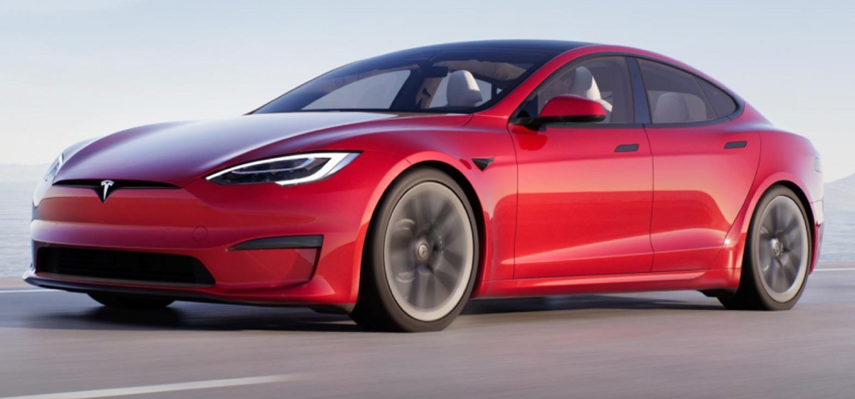 A red 2022 Tesla Model S Plaid driving down a road. Similar to the one seen in the drag race of this article