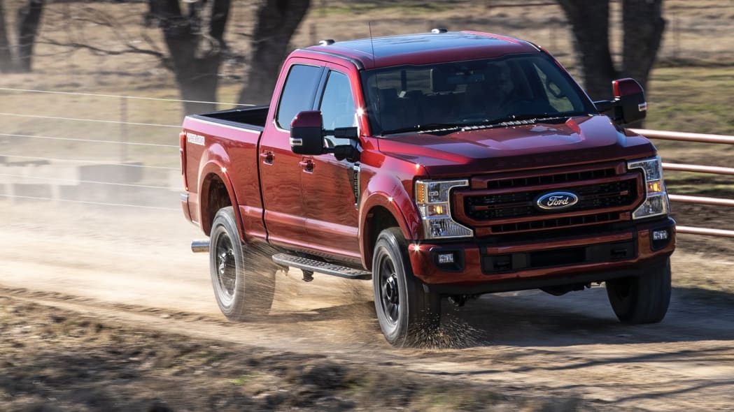 A red 2022 Ford F-250 Super Duty on a dirt road