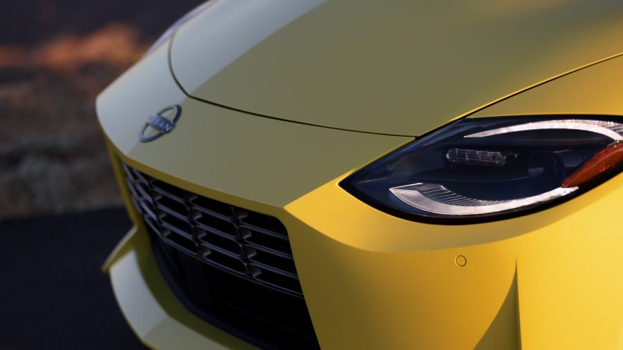 The headlights of the 2023 Nissan Z, seen in yellow at sunset