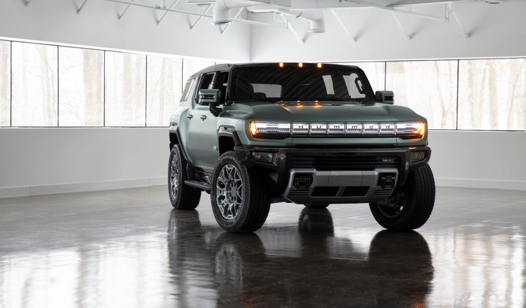 The GMC Hummer EV in a photo studio, seen with olive drab matte paint