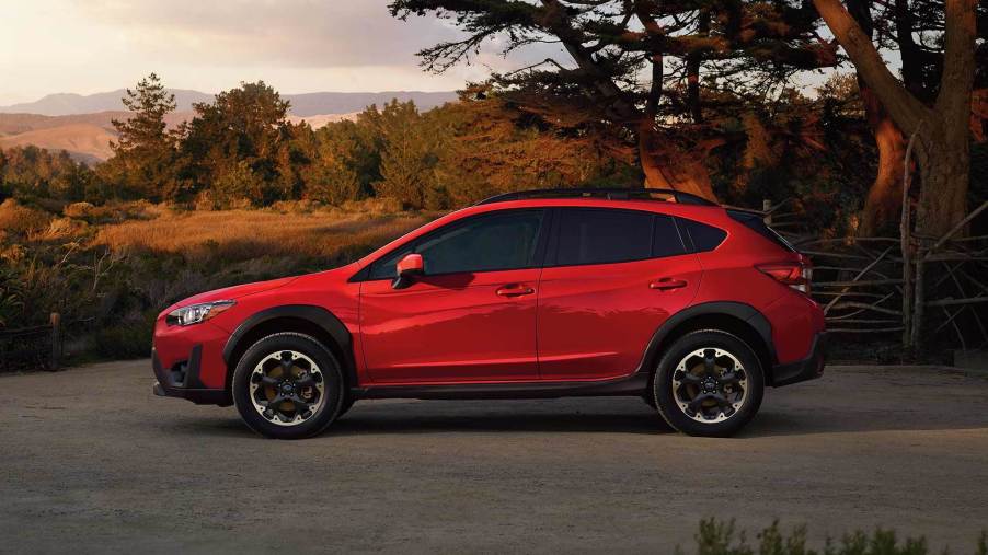 A red 2021 Subaru Crosstrek with mountains in the background.