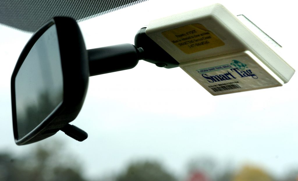A Smart Tag electronic toll transponder stuck to a car windshield