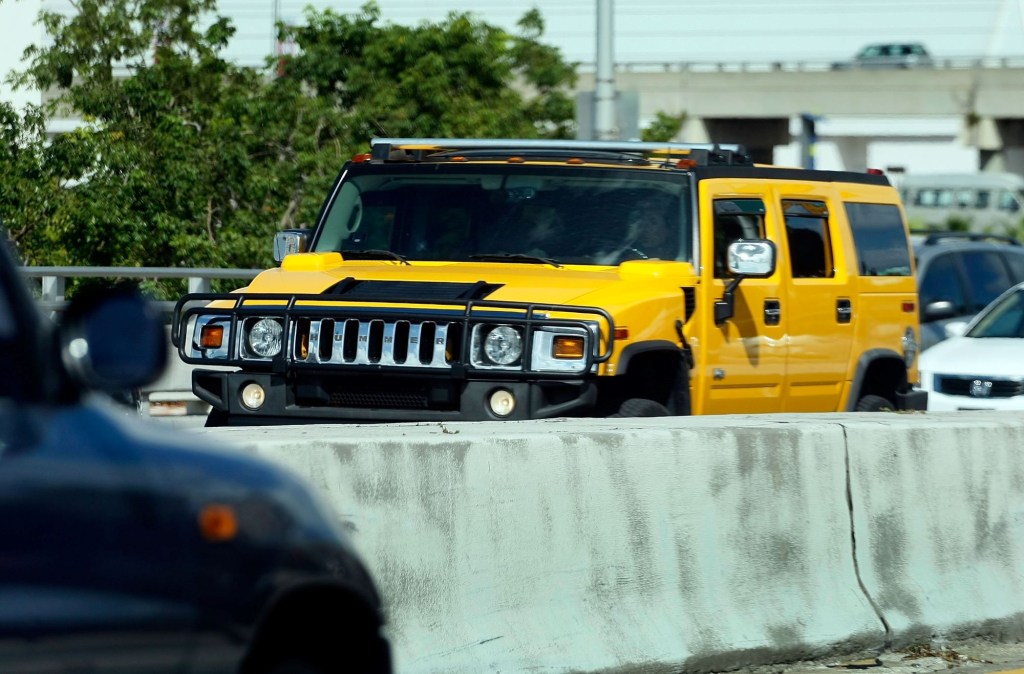 The AM General Hummer in yellow driving in Miami, Florida