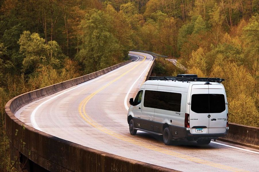 Airstream camper van driving down the road