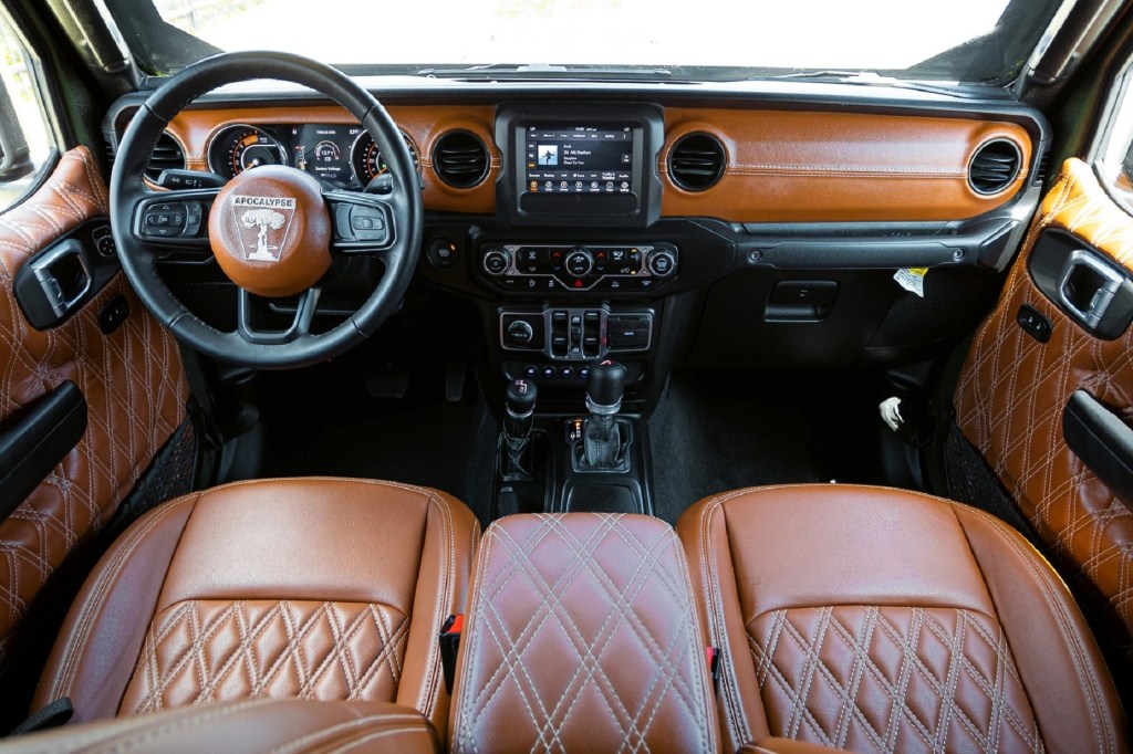 The brown-and-black front seats and dashboard of an Apocalypse Hellfire 6x6
