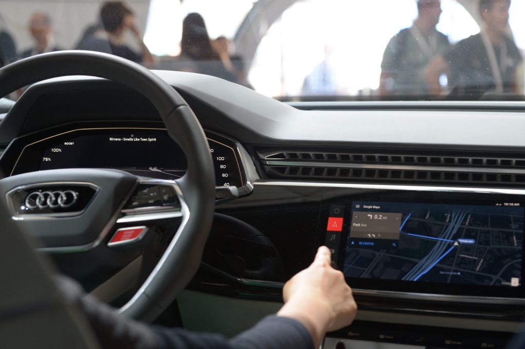 The cockpit of an Audi Q8 prototype with an infotainment system displaying advanced safety features in May 2017