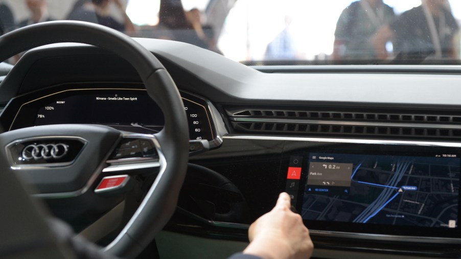 The cockpit of an Audi Q8 prototype with an infotainment system displaying advanced safety features in May 2017