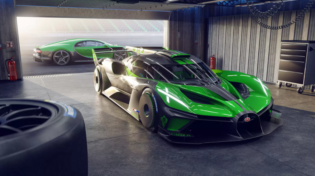 A green Bugatti Bolide race car parked in a garage next to a racetrack