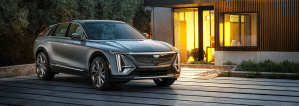The Cadillac Lyriq EV SUV parked outside a luxury home