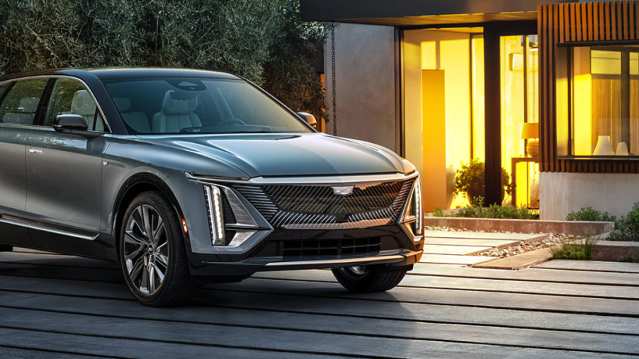 The Cadillac Lyriq EV SUV parked outside a luxury home
