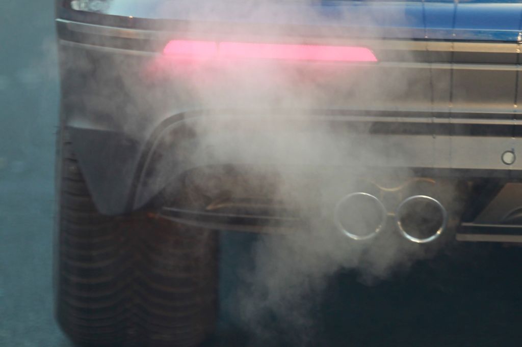 A car emitting gas exhaust fumes from its tailpipe in Cologne, Germany