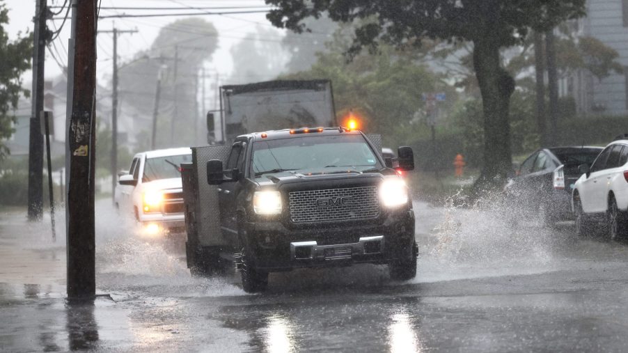 Cars Driving Through Heavy Rain With Hazard Lights On