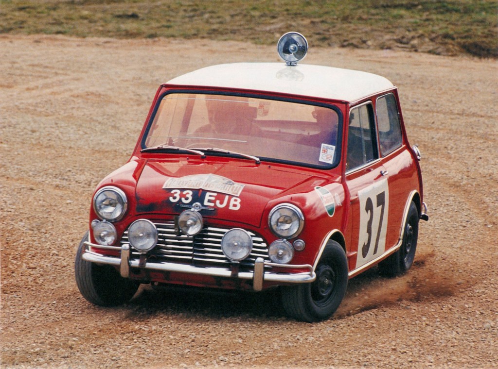A red-and-white classic Mini Cooper S at the 1964 Monte Carlo Rally