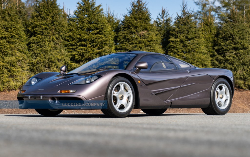 The Creighton Brown 1995 McLaren F1 parked by some pine trees
