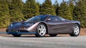 The Creighton Brown 1995 McLaren F1 parked by some pine trees