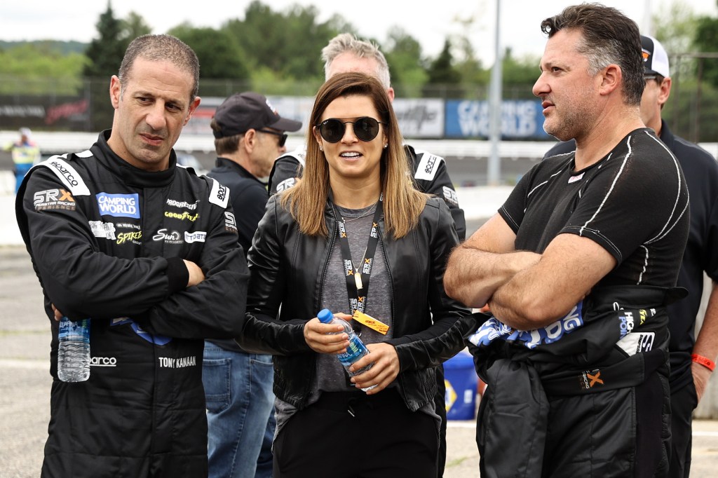 CBS driver analyst Danica Patrick talks with SRX drivers Tony Kanaan (left) and Tony Stewart on the grid prior to the Inaugural Superstar Racing Experience Event at Stafford Motor Speedway on June 12, 2021, in Stafford Springs, Connecticut. Patrick is one of few women in motorsports.