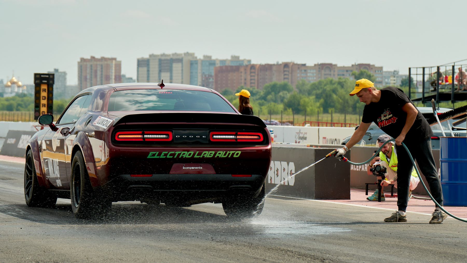 A Dodge Challenger getting hosed down before a race at the "Moscow Mile"