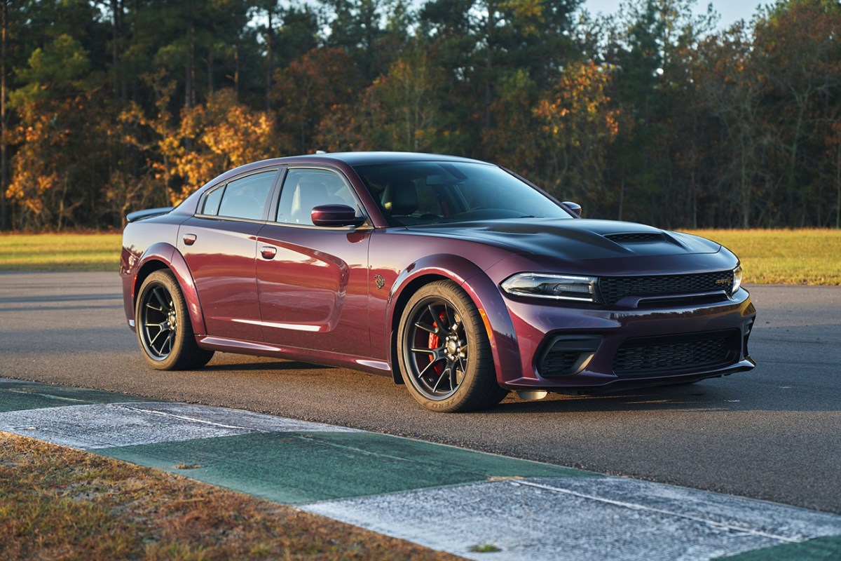 Purple Dodge Charger Hellcat Redeye seen from a distance on a race track.