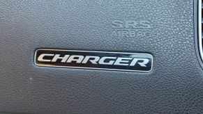 Dodge Charger logo on the dashboard of car.