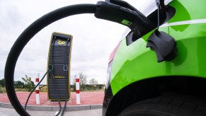 An electric car stands at a charging station.