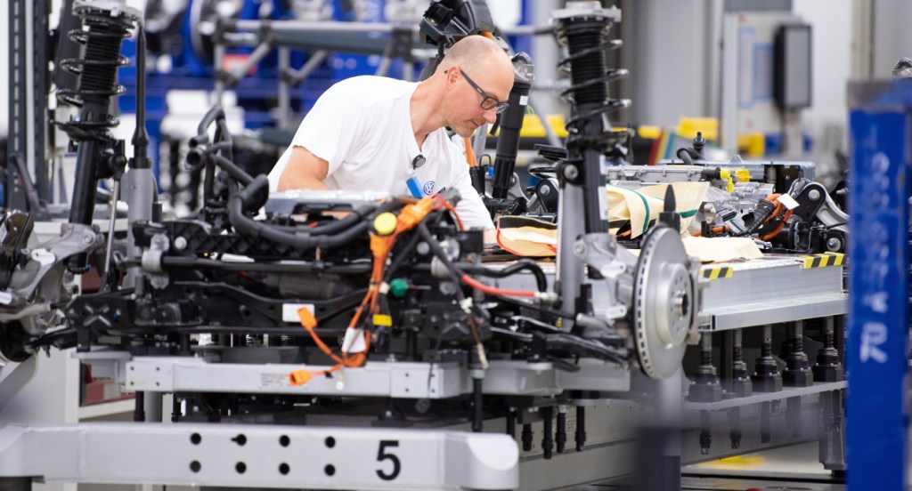 Volkswagen employees wire the battery on a line for the VW ID.3 electric vehicle during a press tour of Volkswagen's Transparent Factory. 35 all-electric vehicles are produced daily at the Dresden site.