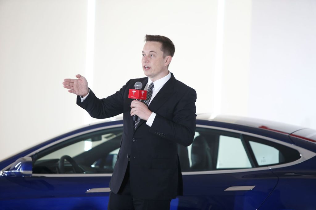 Elon Musk speaking during a press conference on Tesla self-driving capabilities